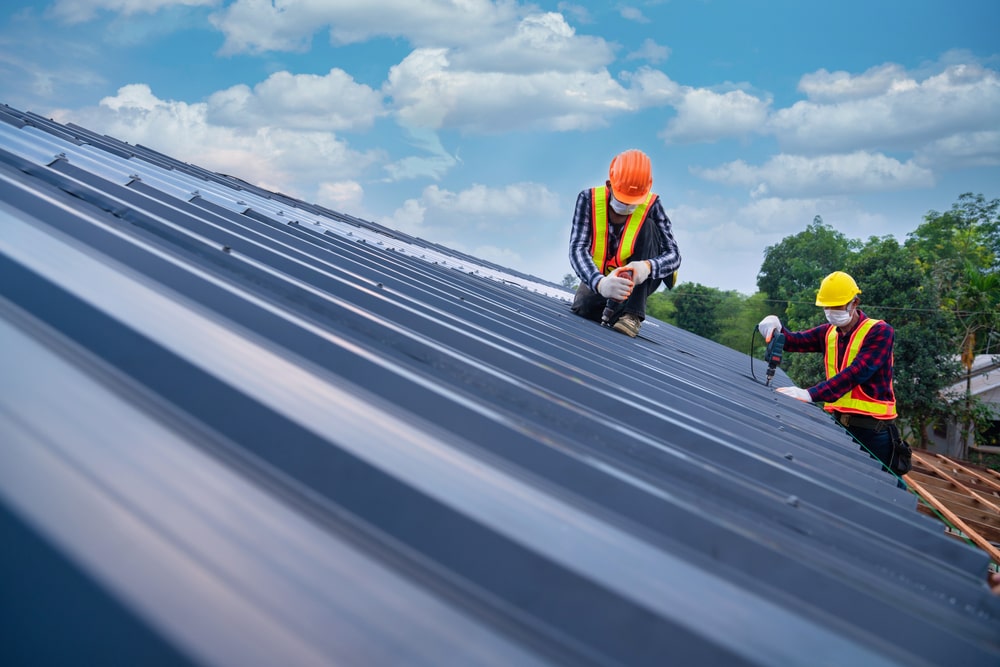 2 men working on metal roof